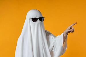 A person in a ghost costume pointing at something photo