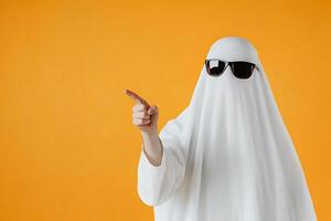 A person in a ghost costume pointing at something photo