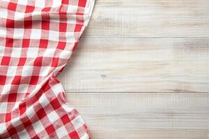 Red and white checkered tablecloth on wooden table photo
