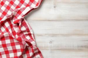 Red and white checkered tablecloth on wooden table photo
