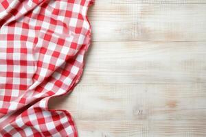 Checkered tablecloth on wooden table top view photo