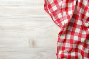 Red and white checkered cloth on wooden table photo