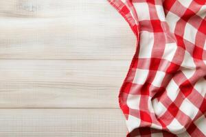 Red and white checkered tablecloth on wooden table photo