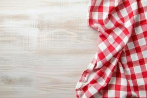 Red and white checkered cloth on wooden table photo