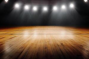 An empty basketball court with lights shining on it photo