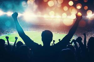 A crowd of people cheering at a soccer game photo