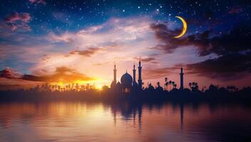 Islamic mosque and crescent moon at sunset photo