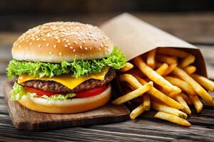A hamburger and french fries on a wooden table photo