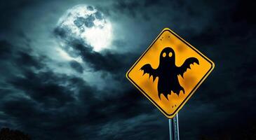 A street sign with a ghost on it in front of a full moon photo