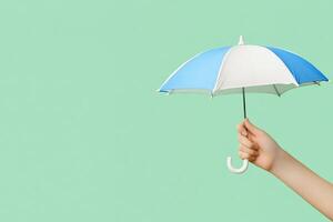 A person holding an umbrella over a green background photo
