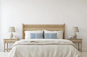 A white bed with a blue and white blanket photo