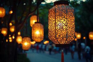 Chinese lanterns hanging from trees in the evening photo
