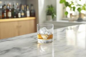 A glass of whiskey sitting on a counter photo