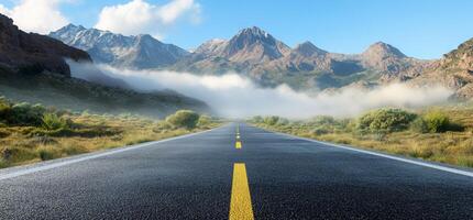 An empty road with mountains in the background photo