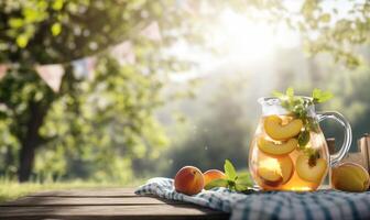 A pitcher of peach juice on a picnic table photo