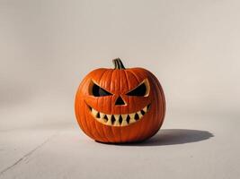 A pumpkin with a scary face is sitting on the ground. photo