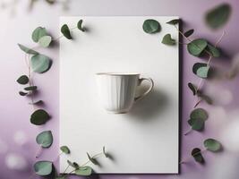 Coffee cup and eucalyptus leaves on blank poster with soft purple backdrop. photo