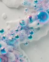 A close up of bubbles and soap on a white surface photo