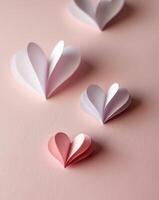 Intricately cut paper hearts on a soft pink background for a valentine s day card composition photo
