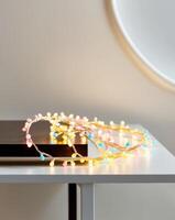 A colorful string of lights is curled up on a table photo
