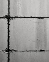 Rough concrete block texture with visible seams and imperfections photo
