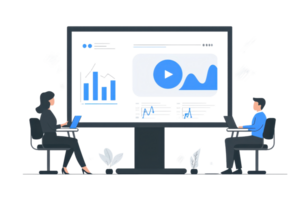 Two individuals engage in a collaborative meeting in front of a large screen displaying analytics and multimedia content. png