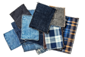 Assorted fabric swatches including denim and plaid patterns stacked on a transparent background. showcasing various textures and styles. png
