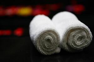 Two white towels on a black surface photo
