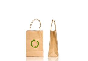 Paper bag with green arrow on white background photo