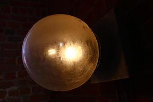 Old globe lamp made of glass with dark background photo