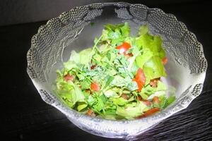 Highlighted glass salad bowl with dark background photo
