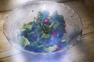 Glass salad bowl with unusual stray light effects photo