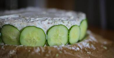 Preparation of Smorgastarta, a typical Swedish dish, with cucumber slices photo