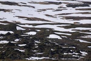 Snow patches and rocks at the valley Karkevagge in Northern Sweden photo