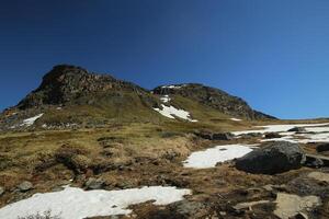 Mountains, grassland and rocks at the valley Karkevagge in Northern Sweden photo
