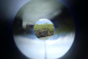Unusual shot through a colored tube, a cliff at the stream Abiskojakka can be seen photo