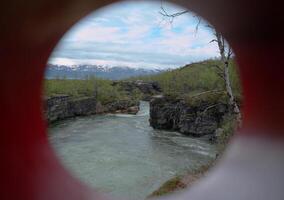 Unusual shot through a colored tube, the stream Abiskojakka can be seen photo