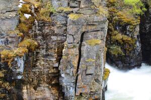 Slate cliffs at the stream Abiskojakka in Sweden photo