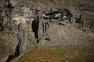 Rock formation resembling a dark castle in the valley Karkevagge in northern Sweden photo