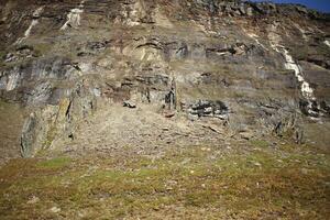 Rock formation resembling a dark castle in the valley Karkevagge in northern Sweden photo