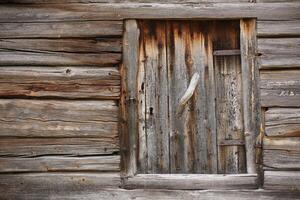 Old and rustic hatch on a log hut photo