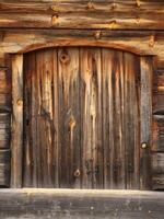 Old and rustic hatch on a log hut photo