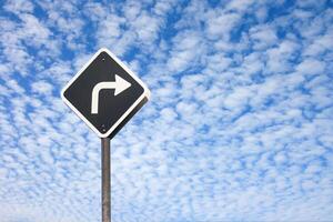 A black and white sign with an arrow pointing left photo
