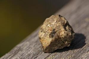 Rock with a shiny golden surface in sunlight photo