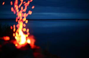 Defocused campfire in front of lake Malgomaj in Sweden photo
