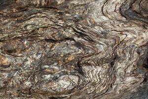 Layers of slate stone eroded by water photo