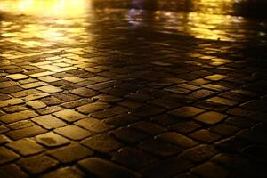 Shiny pavement in the light of christmas decorations in the city photo