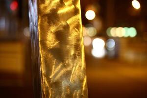 Brushed metal bar in the night with defocused background photo