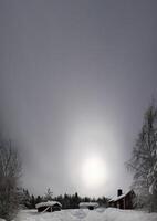Unusual vertical panoramic shot of Swedish wood house in misty night photo