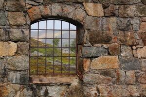 View through the barred window of an old railway turntable at Riksgransen in Sweden photo
